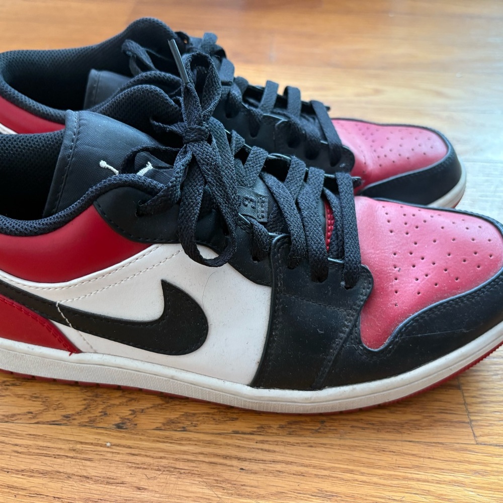 Nike Air Jordan’s Low Black, Red, and White Low-Top Sneakers